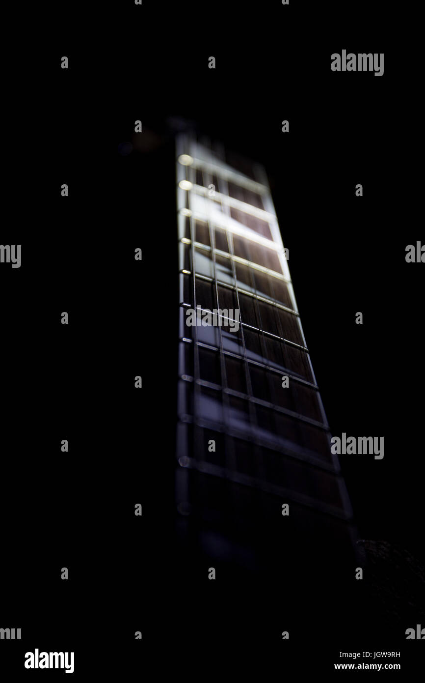 Neck of electric guitar showing shark tooth inlaid fretboard. Stock Photo