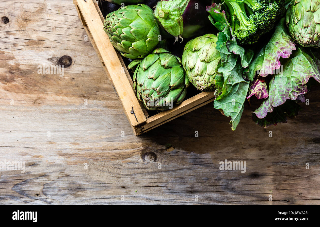 Cooking background harvest concept. Fresh organic green vegetables in wooden box Stock Photo