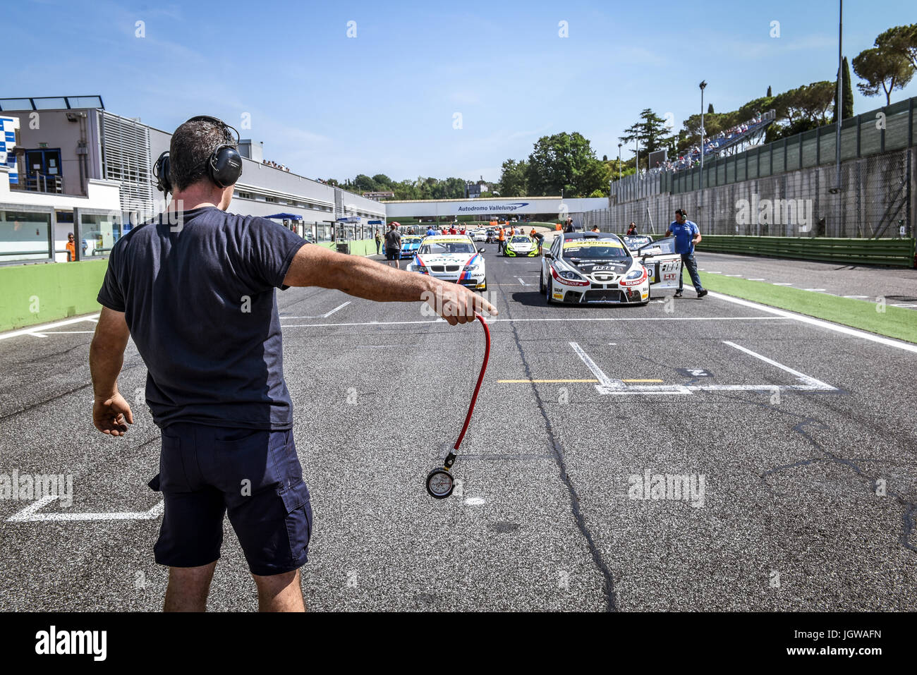 Italian Super Cup cars positioning on starting grid, mechaninc point out position to Bmw car Stock Photo
