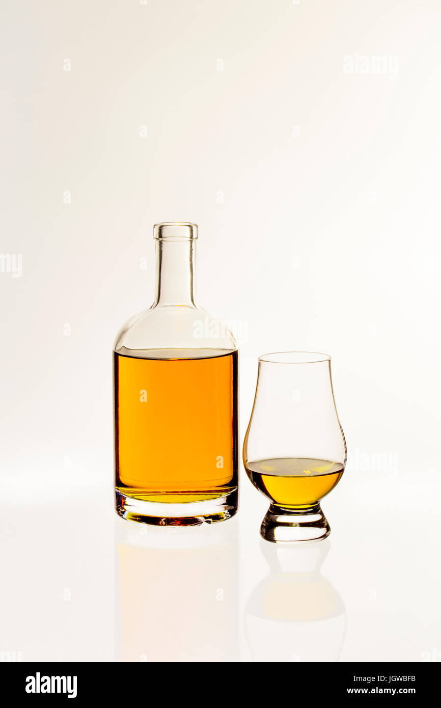 Bottle of Whiskey with Nosing Glas on white background Stock Photo