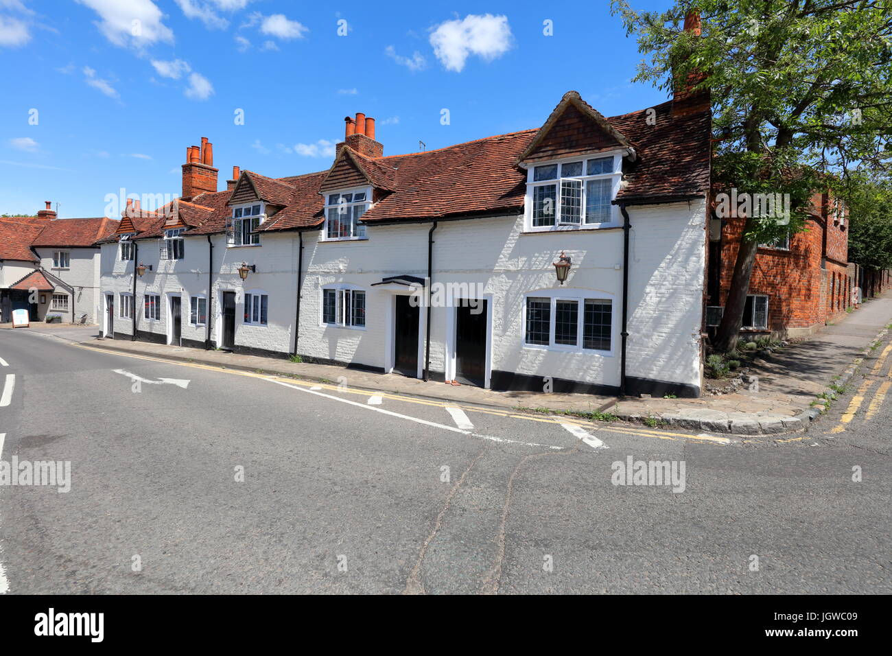 The Little house as it is now known has a row of terraced houses alongside the main road through the village in this quiet village location. Stock Photo