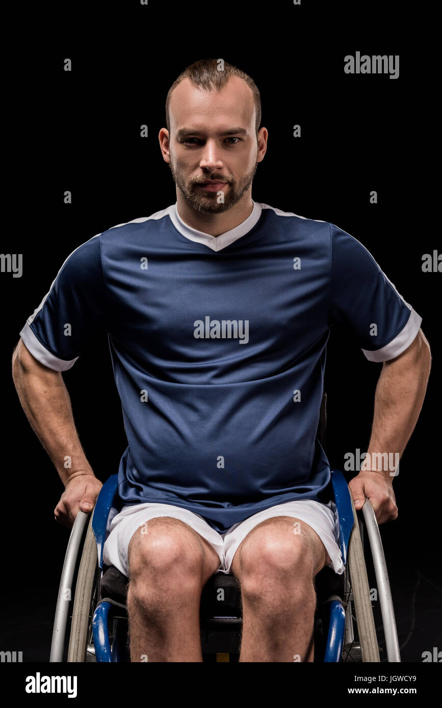 paralympic in wheelchair dressed in sportswear looking at camera