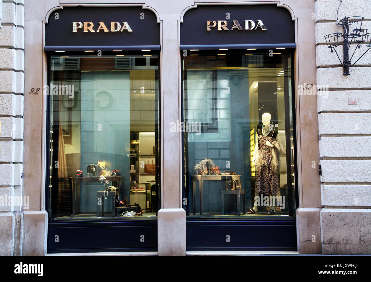 Pedestrians walk past of the shop window of Prada store in Rome Italy ...
