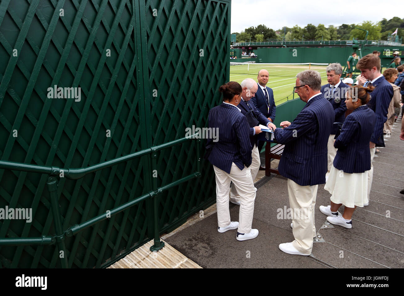 Line judges wait outside court five on day eight of the Wimbledon