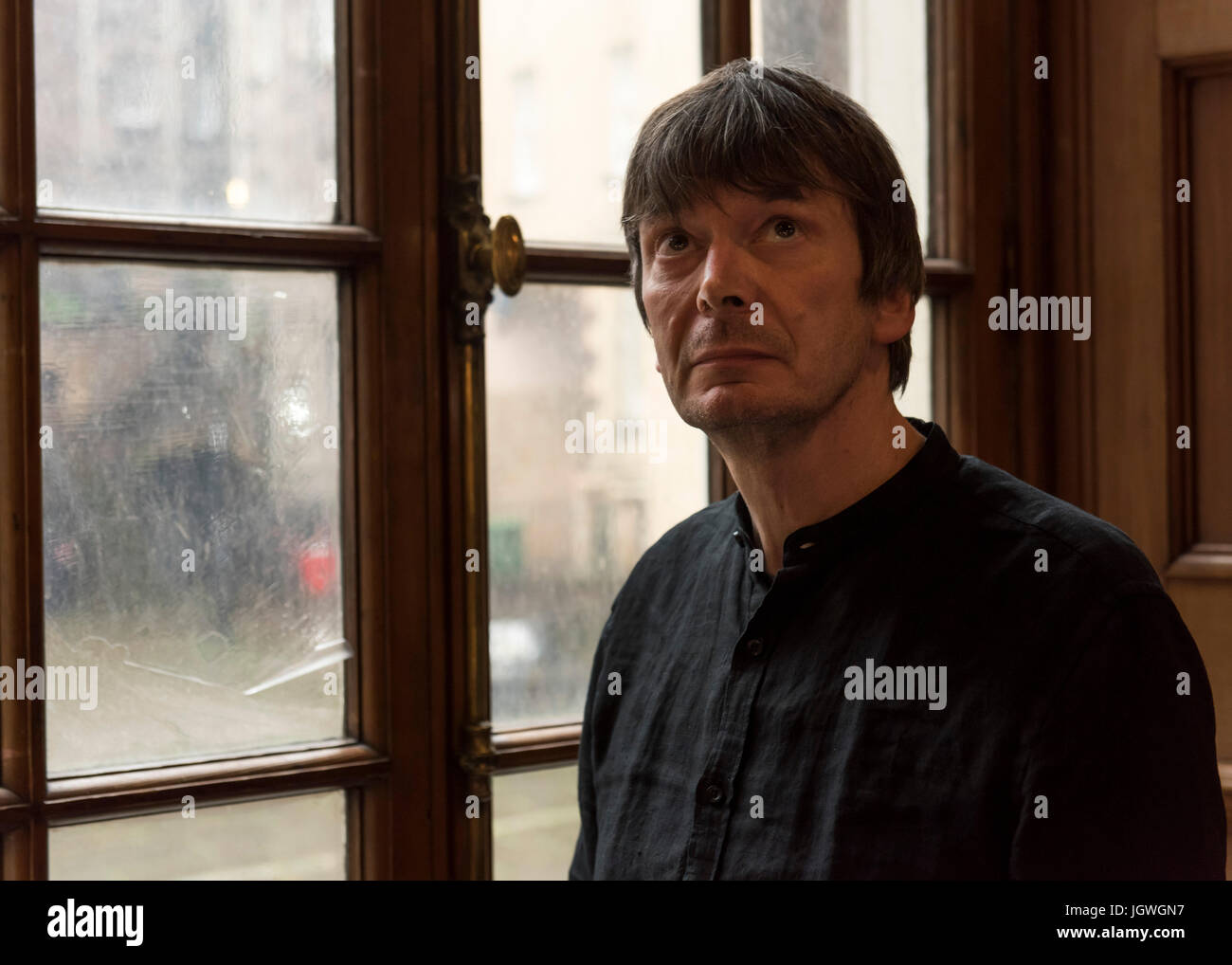 Thursday 29th of June 2017: Ian Rankin at the Writers Museum with a copy of his first book, Knots and Crosses. Joining the ranks of Sir Walter Scott, Robert Burns and Robert Louis Stevenson; author Ian Rankin will be celebrated in a new exhibition at Edinburgh’s Writers’ Museum.  A rare selection of personal items, manuscripts and images belonging to the best-selling writer will be displayed in a new exhibition celebrating the 30th anniversary of his much-loved super sleuth, Detective Inspector Rebus.  Co-curated between the author and the Museum, Rebus30 explores the relationship between Rank Stock Photo
