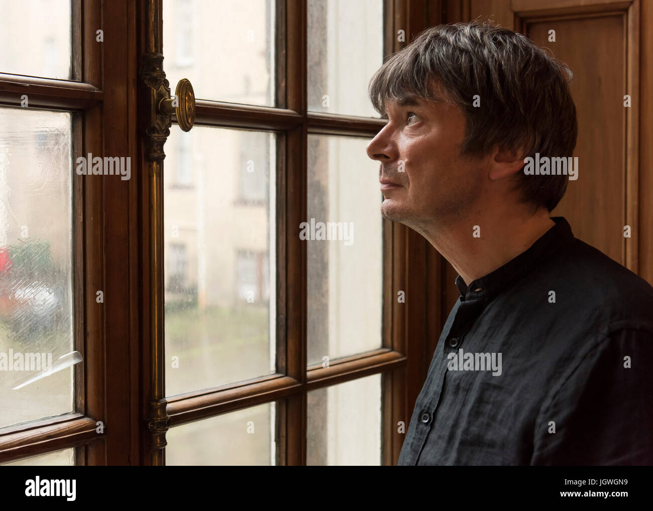 Thursday 29th of June 2017: Ian Rankin at the Writers Museum with a copy of his first book, Knots and Crosses.  Joining the ranks of Sir Walter Scott, Robert Burns and Robert Louis Stevenson; author Ian Rankin will be celebrated in a new exhibition at EdinburghÕs WritersÕ Museum.  A rare selection of personal items, manuscripts and images belonging to the best-selling writer will be displayed in a new exhibition celebrating the 30th anniversary of his much-loved super sleuth, Detective Inspector Rebus.  Co-curated between the author and the Museum, Rebus30 explores the relationship between Ran Stock Photo