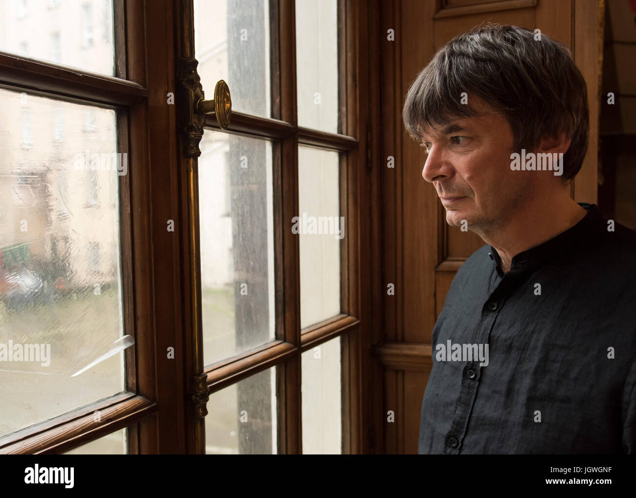 Thursday 29th of June 2017: Ian Rankin at the Writers Museum with a copy of his first book, Knots and Crosses.  Joining the ranks of Sir Walter Scott, Robert Burns and Robert Louis Stevenson; author Ian Rankin will be celebrated in a new exhibition at EdinburghÕs WritersÕ Museum.  A rare selection of personal items, manuscripts and images belonging to the best-selling writer will be displayed in a new exhibition celebrating the 30th anniversary of his much-loved super sleuth, Detective Inspector Rebus.  Co-curated between the author and the Museum, Rebus30 explores the relationship between Ran Stock Photo