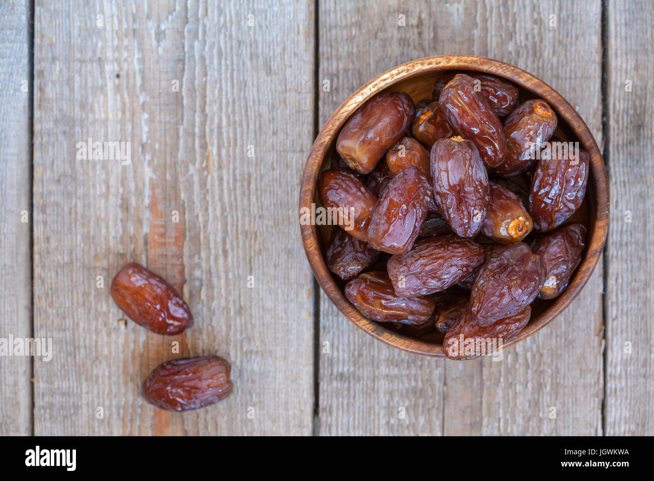 Fresh royal medjool dates in wooden bowl. Love for a healthy vegan food concept Stock Photo Alamy