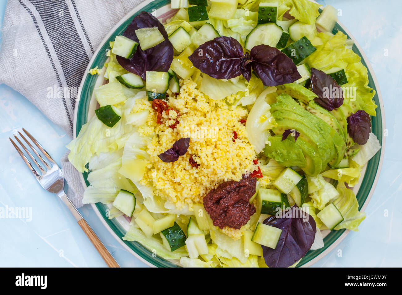 Vegetarian green salad with basil and couscous. Love for a healthy vegan food concept. Stock Photo