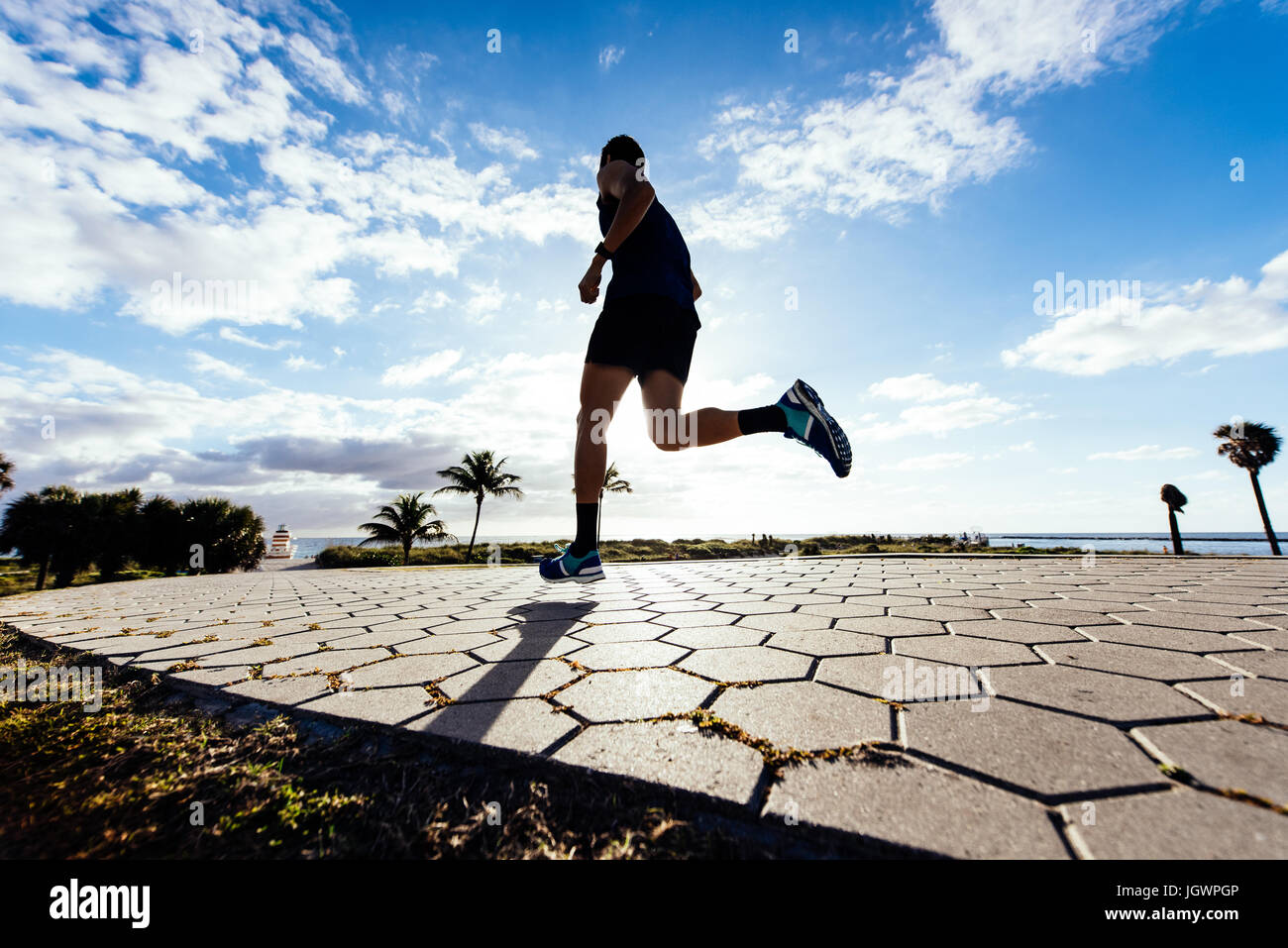 Young man exercising, running outdoors, low angle view, South Point Park, Miami Beach, Florida, USA Stock Photo