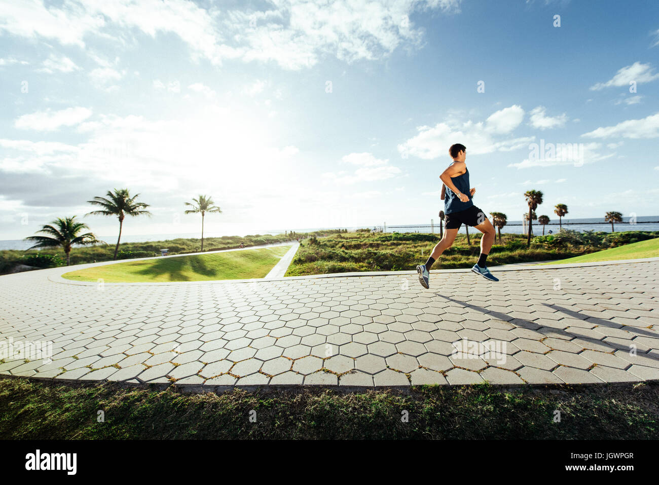 Young man exercising, running outdoors, South Point Park, Miami Beach, Florida, USA Stock Photo
