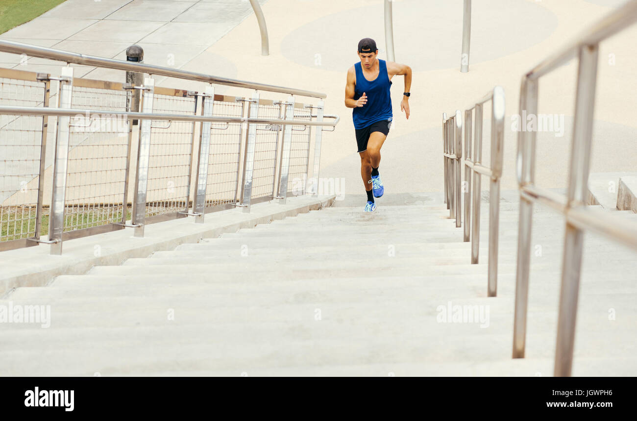 Young man exercising outdoors, running up steps, high angle view, South Point Park, Miami Beach, Florida, USA Stock Photo