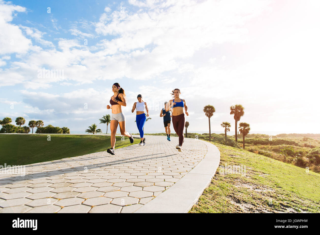 Group of friends exercising, running, outdoors, low angle view, Point Park, Miami Beach, Florida, USA Stock Photo