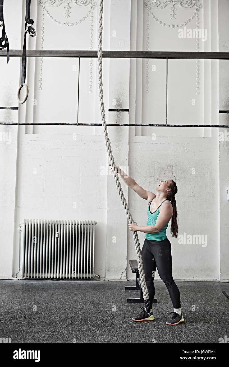 Woman rope climbing in cross training gym Stock Photo Alamy