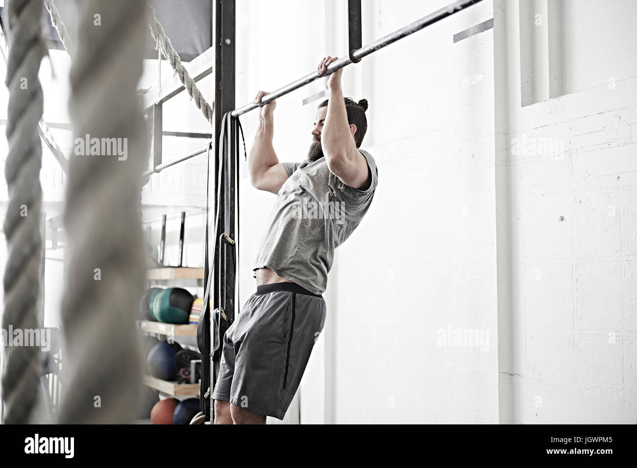 Man doing chin-up in cross training gym Stock Photo