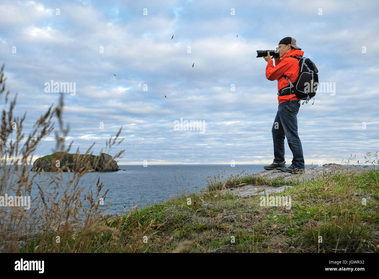 Mid adult man photographing coastline, Saint John, Canada, Stock Photo