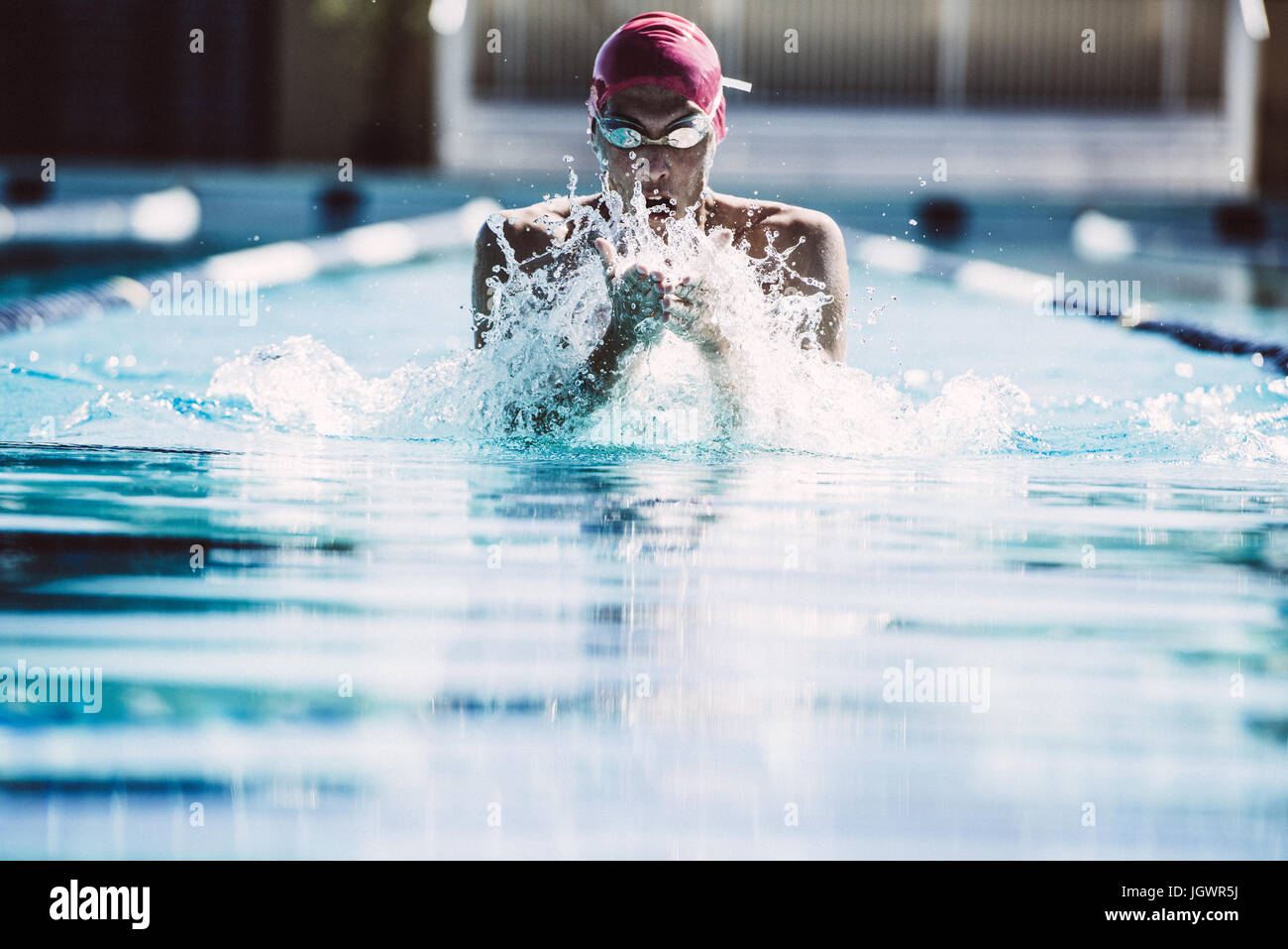 Swimmer splashing pool water on face Stock Photo