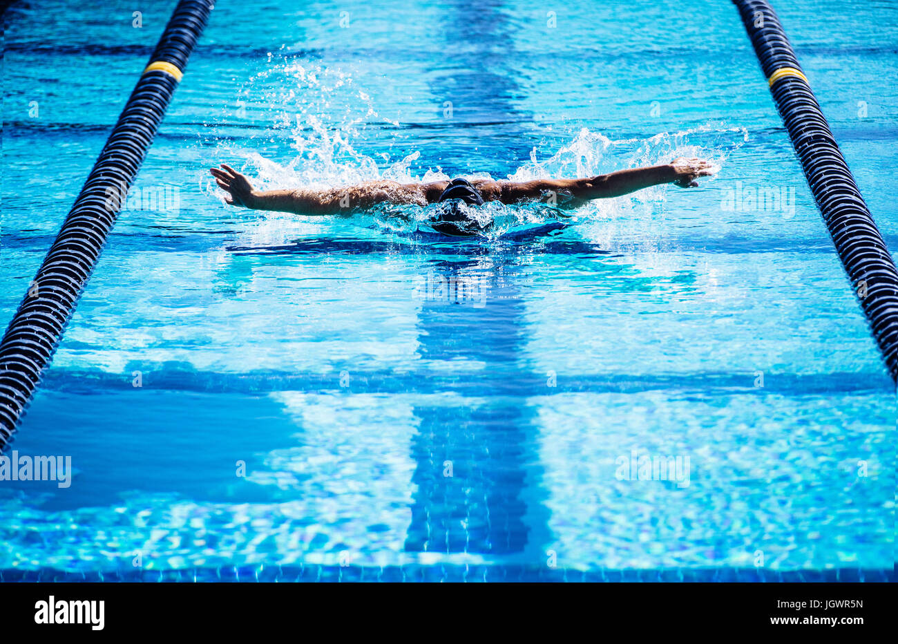 Swimmers doing butterfly stroke in lane Stock Photo