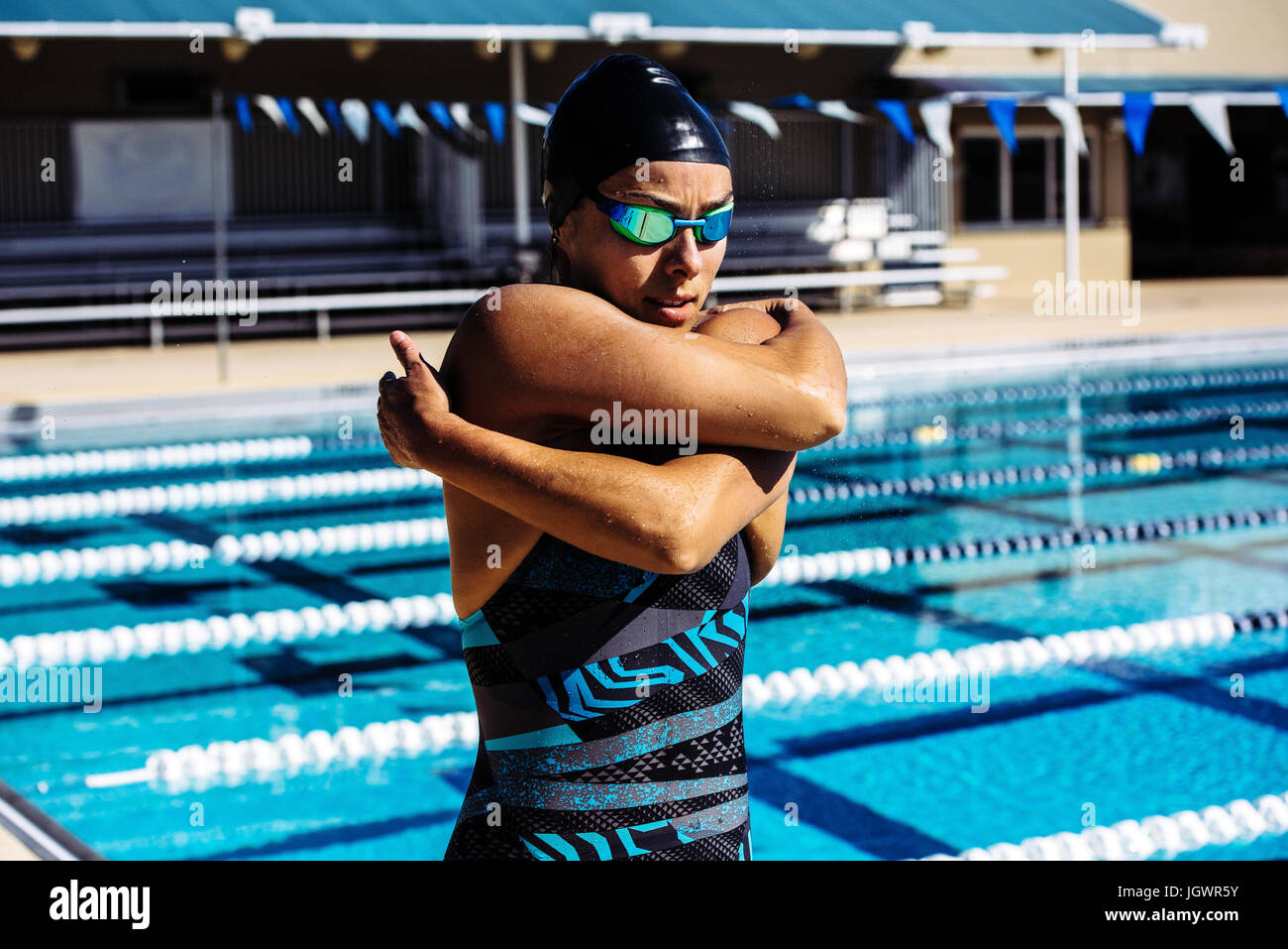 Swimmer in swimming cap and goggles by pool Stock Photo