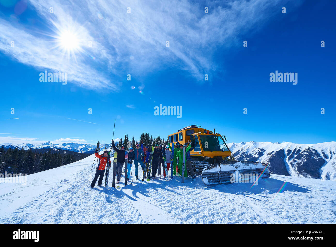 Group portrait of male and female skiers on ski slope by snow coach, Aspen, Colorado, USA Stock Photo