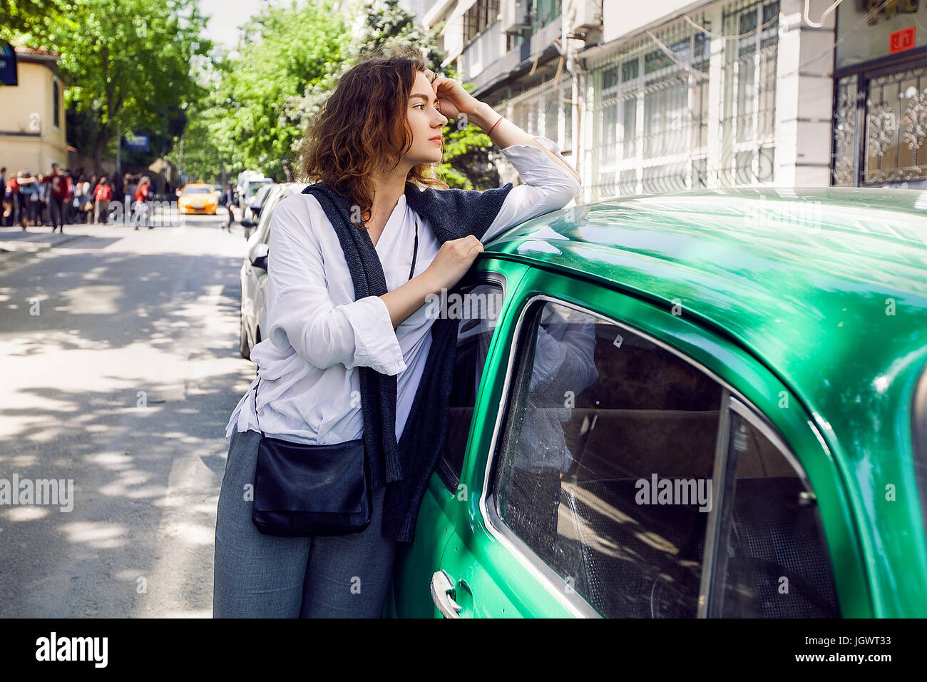 Woman beside green car Stock Photo