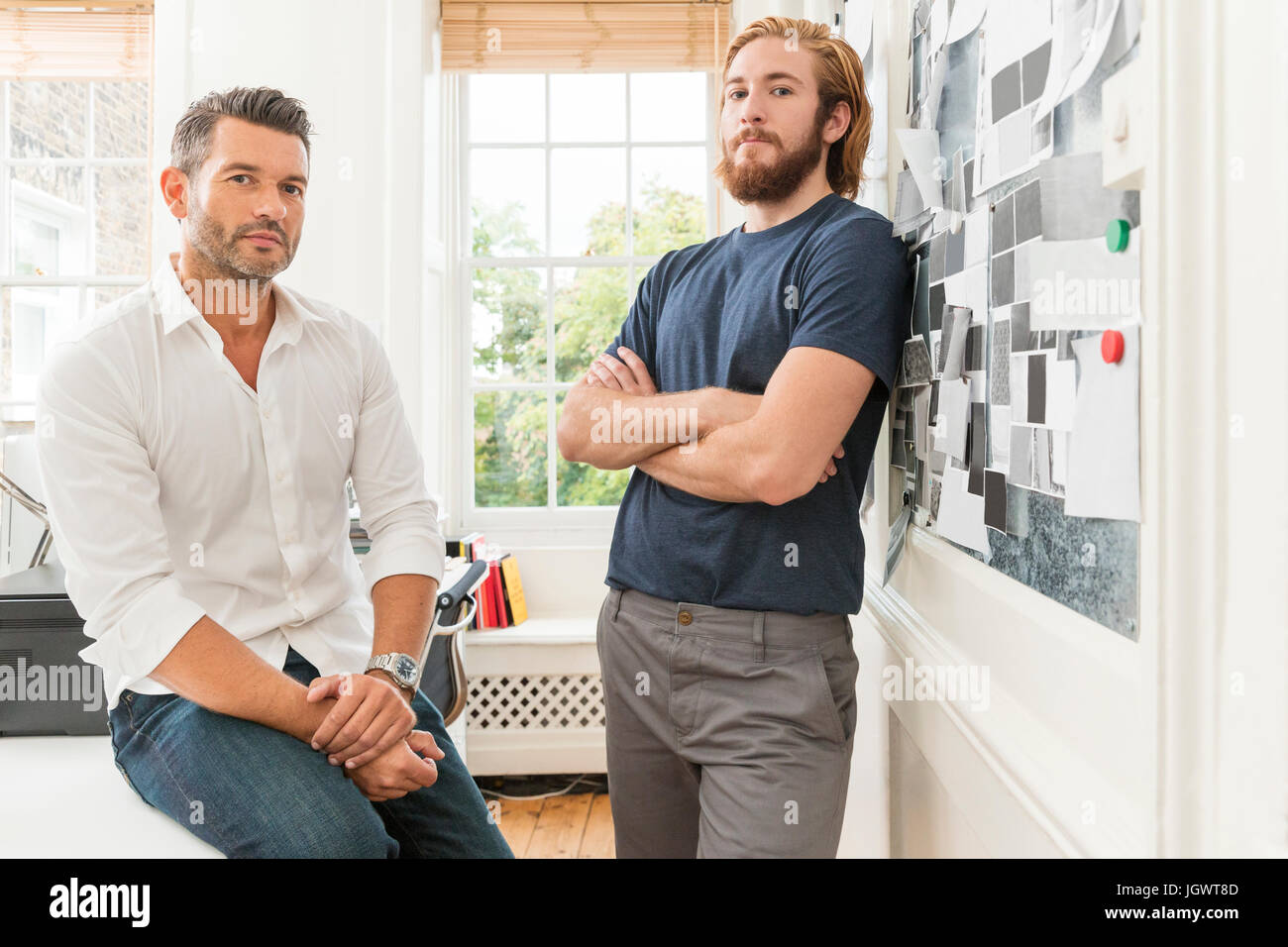 Portrait of two male designers in creative studio Stock Photo - Alamy