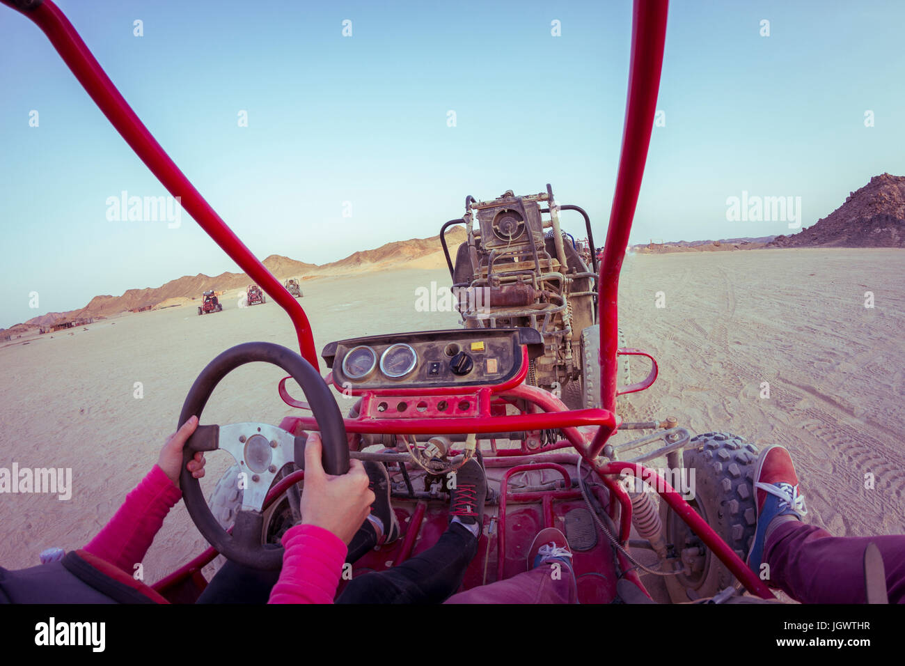 Personal perspective view of two people driving beach buggy in desert, Hurghada, Al Bahr al Ahmar, Egypt Stock Photo