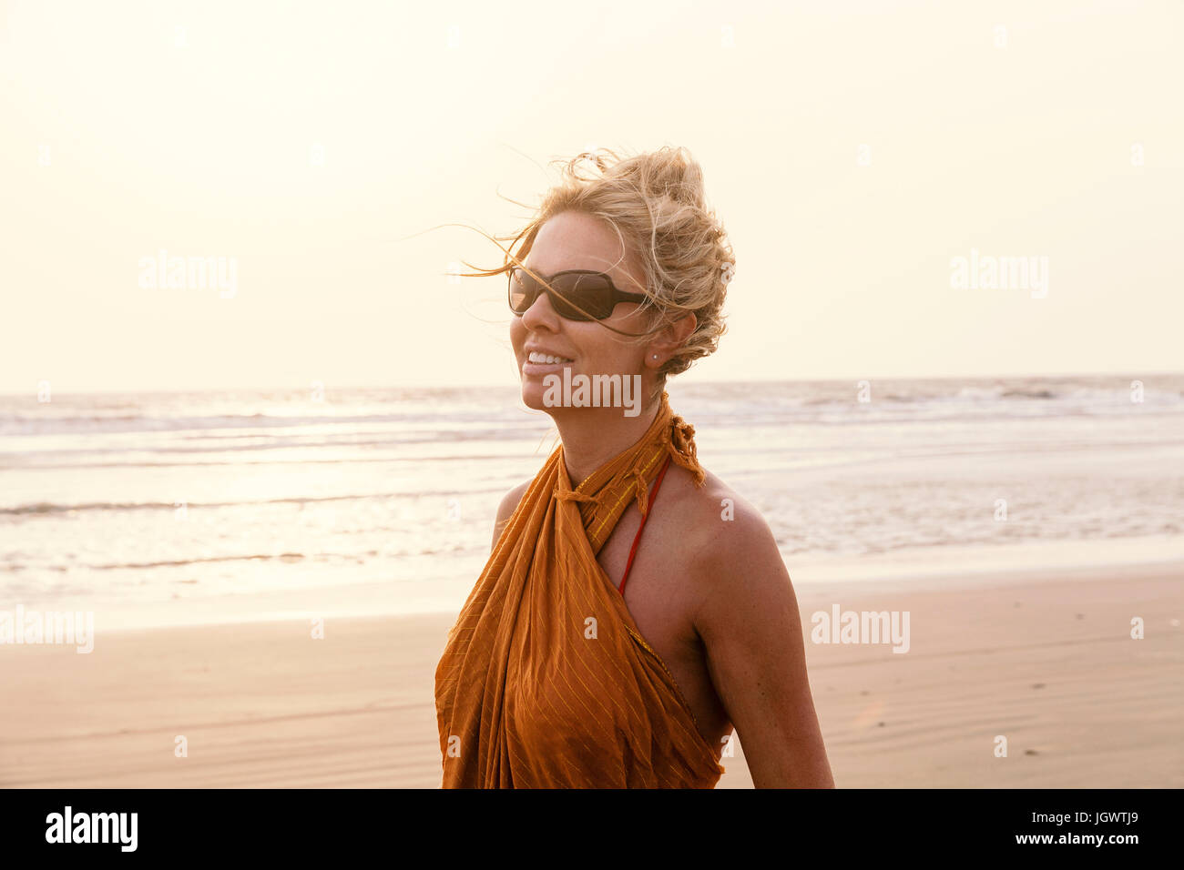 Portrait of woman on beach looking away smiling, Goa, India, Asia Stock Photo