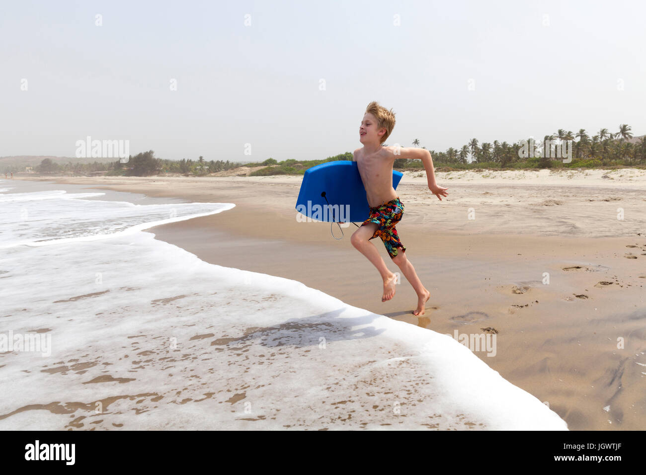 Boy running on beach, Goa, India, Asia Stock Photo