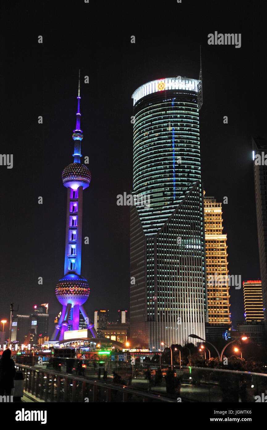 View of modern high-rise buildings lit up in colours at night in ...