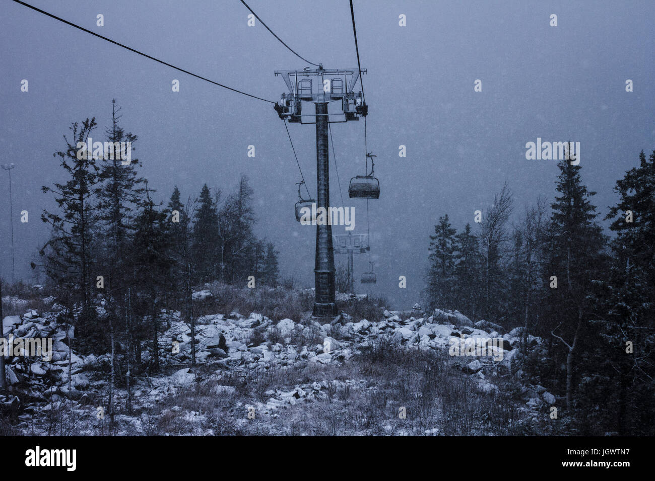 High angle view of chairlift during mountain snowstorm Stock Photo