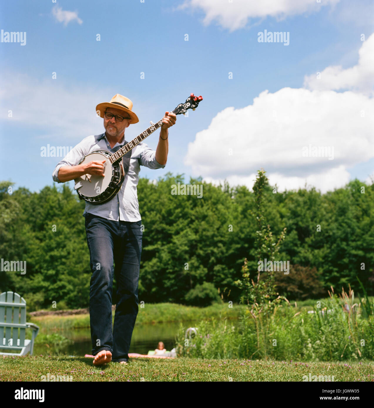 Mature man, outdoors, playing banjo Stock Photo