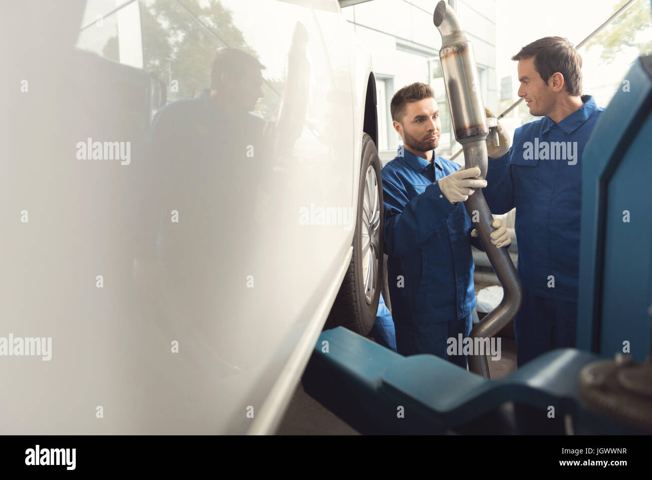 Important detail. Two diligent hardworking colleagues repairing clients