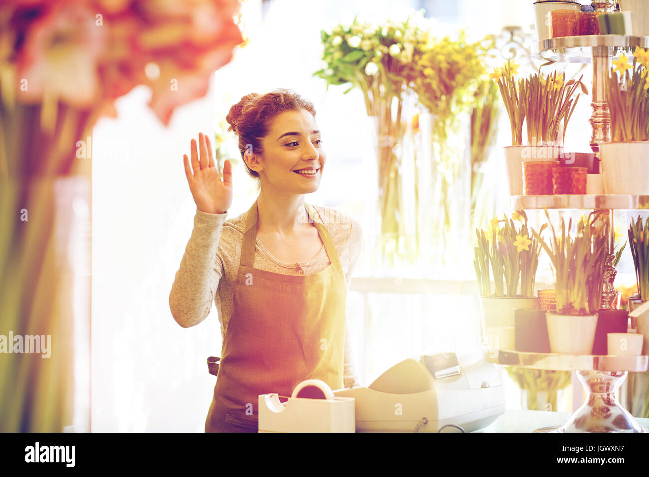 smiling florist woman at flower shop cashbox Stock Photo - Alamy