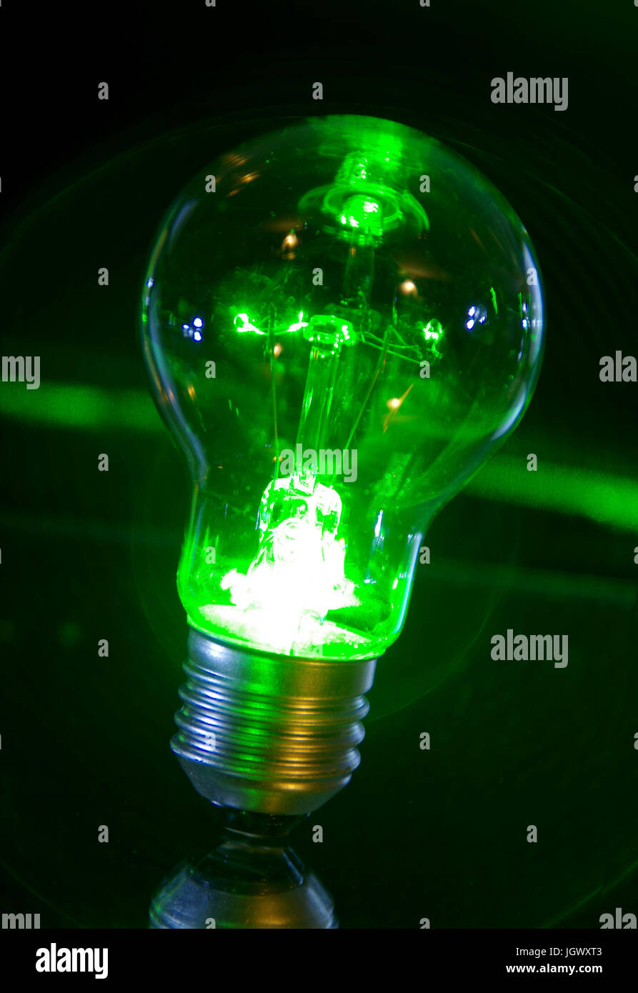Concept of classic bulb green power light with laser rays. Stock Photo