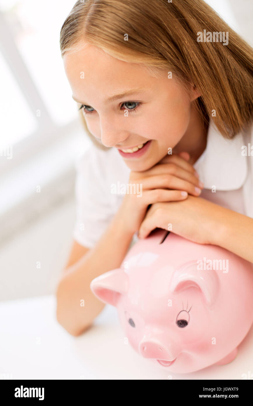 happy girl with piggy bank at home Stock Photo - Alamy