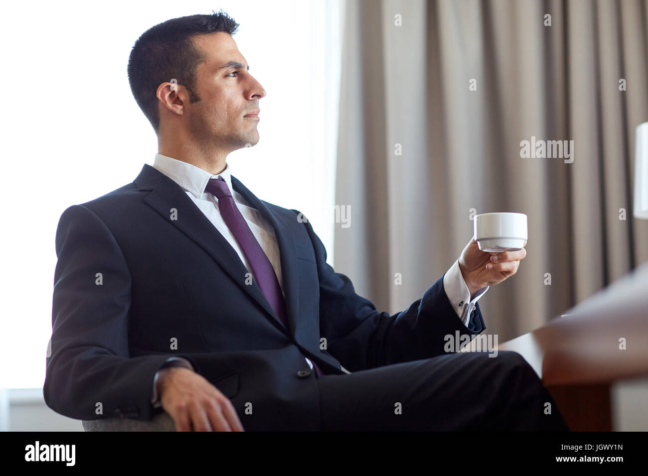 businessman drinking coffee at hotel room Stock Photo Alamy