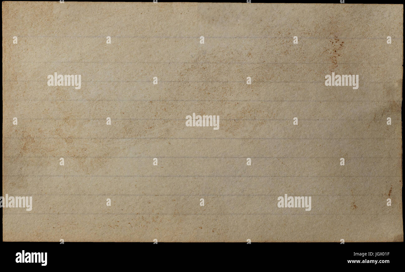 A blank, lined index card, yellowed, aged, stained and weathered for grunge or vintage effect.  Isolated on Black background. Stock Photo