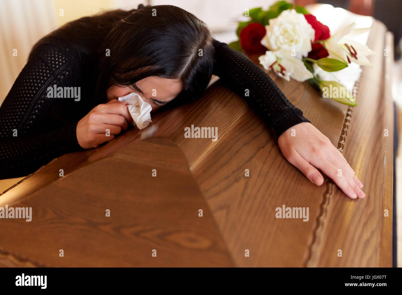 woman with coffin crying at funeral in church Stock Photo Alamy