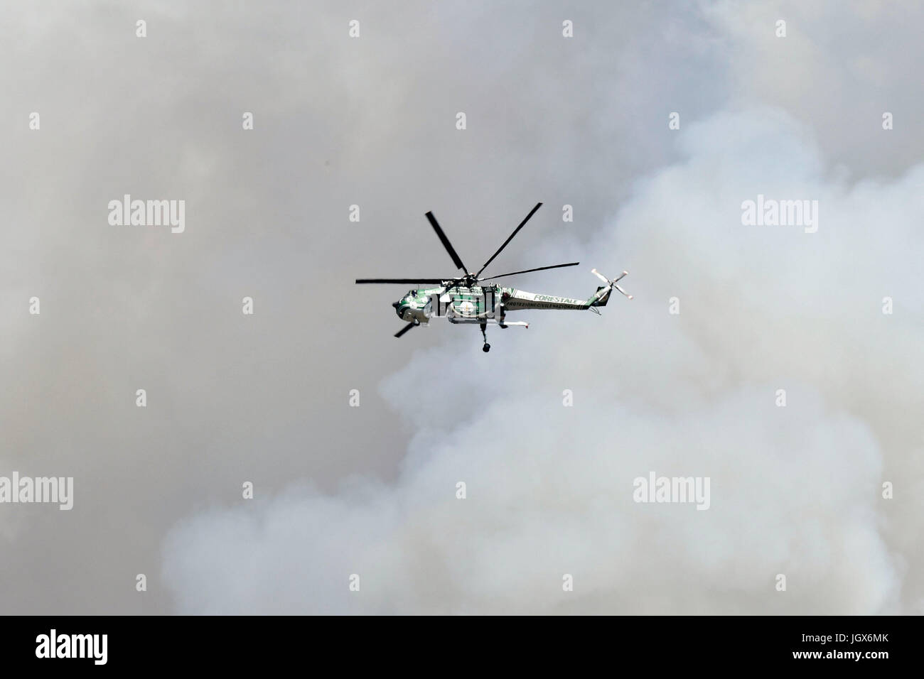 Torre del Greco-Naples, Italy. 11th Jul, 2017. Vesuvius Volcano forest fire Helicopter drops bucket of water Torre del Greco (close to Naples about 12 km) Credit: marco iorio/Alamy Live News Stock Photo