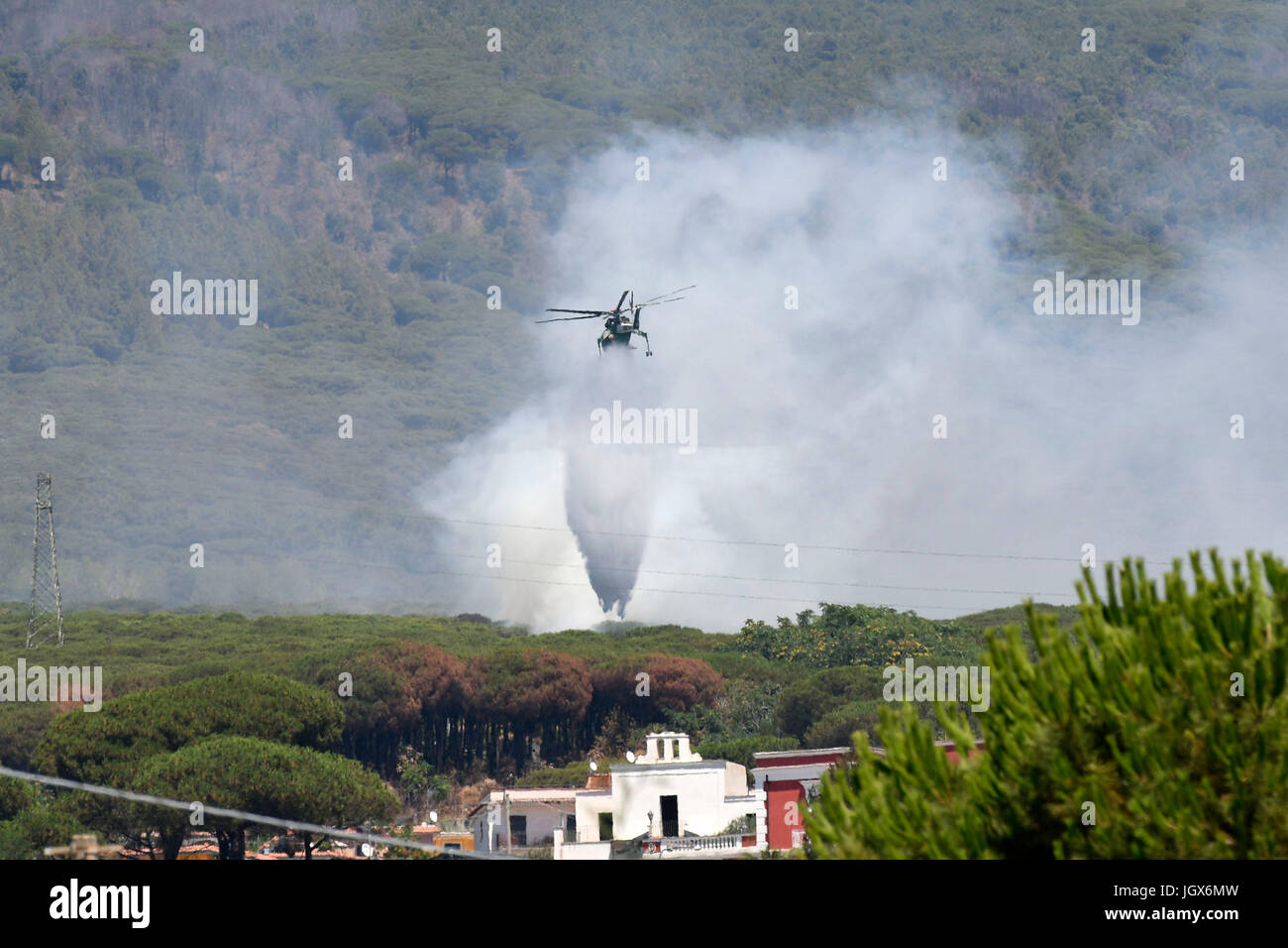 Torre del Greco-Naples, Italy. 11th Jul, 2017. Vesuvius Volcano forest fire Helicopter drops bucket of water Torre del Greco (close to Naples about 12 km) Credit: marco iorio/Alamy Live News Stock Photo