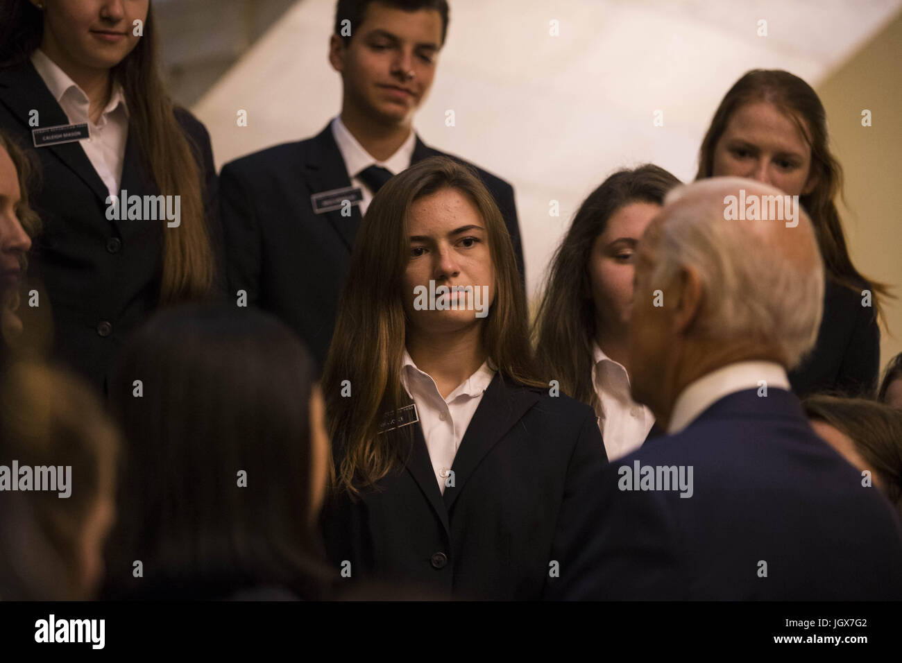 Washington, District of Columbia, USA. 11th July, 2017. A Senate page looks on as Former Vice President Joe Biden speaks to the group after posing for a group photo with Senate Pages' on Capitol Hill on July 11th, 2017. Credit: Alex Edelman/ZUMA Wire/Alamy Live News Stock Photo