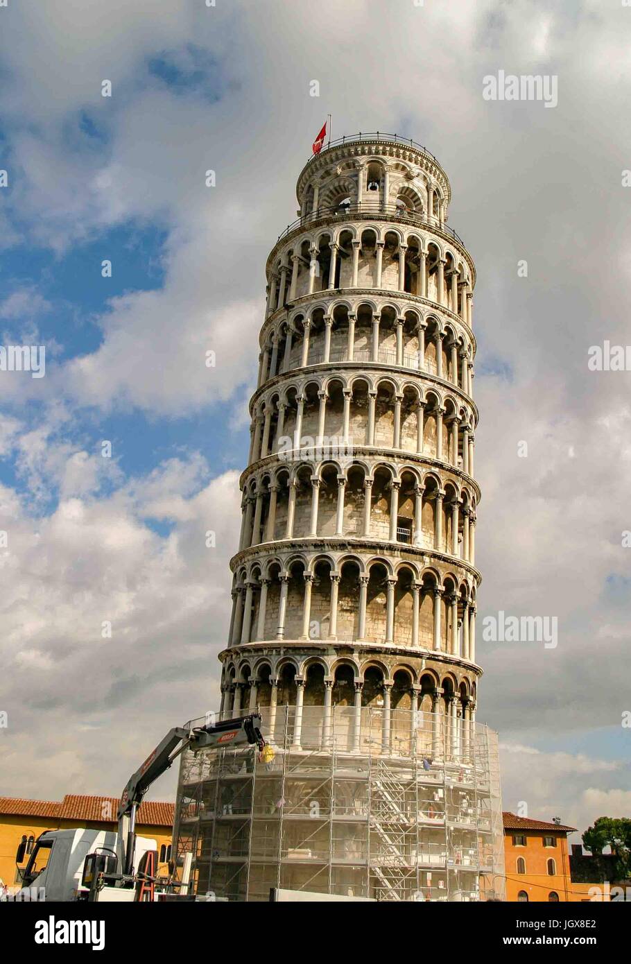 Pisa, Italy. 15th Oct, 2004. The famous medieval Leaning Tower of Pisa Is known worldwide for its unintended tilt. On the historic Piazza dei Miracoli (Square of Miracles), a UNESCO Word Heritage Site, it is the freestanding bell tower (campanile) of the Cathedral of Pisa and a favorite international tourist destination. In this photo the meshwork around the base is because of adjustments being made to the lean of the tower. Credit: Arnold Drapkin/ZUMA Wire/Alamy Live News Stock Photo