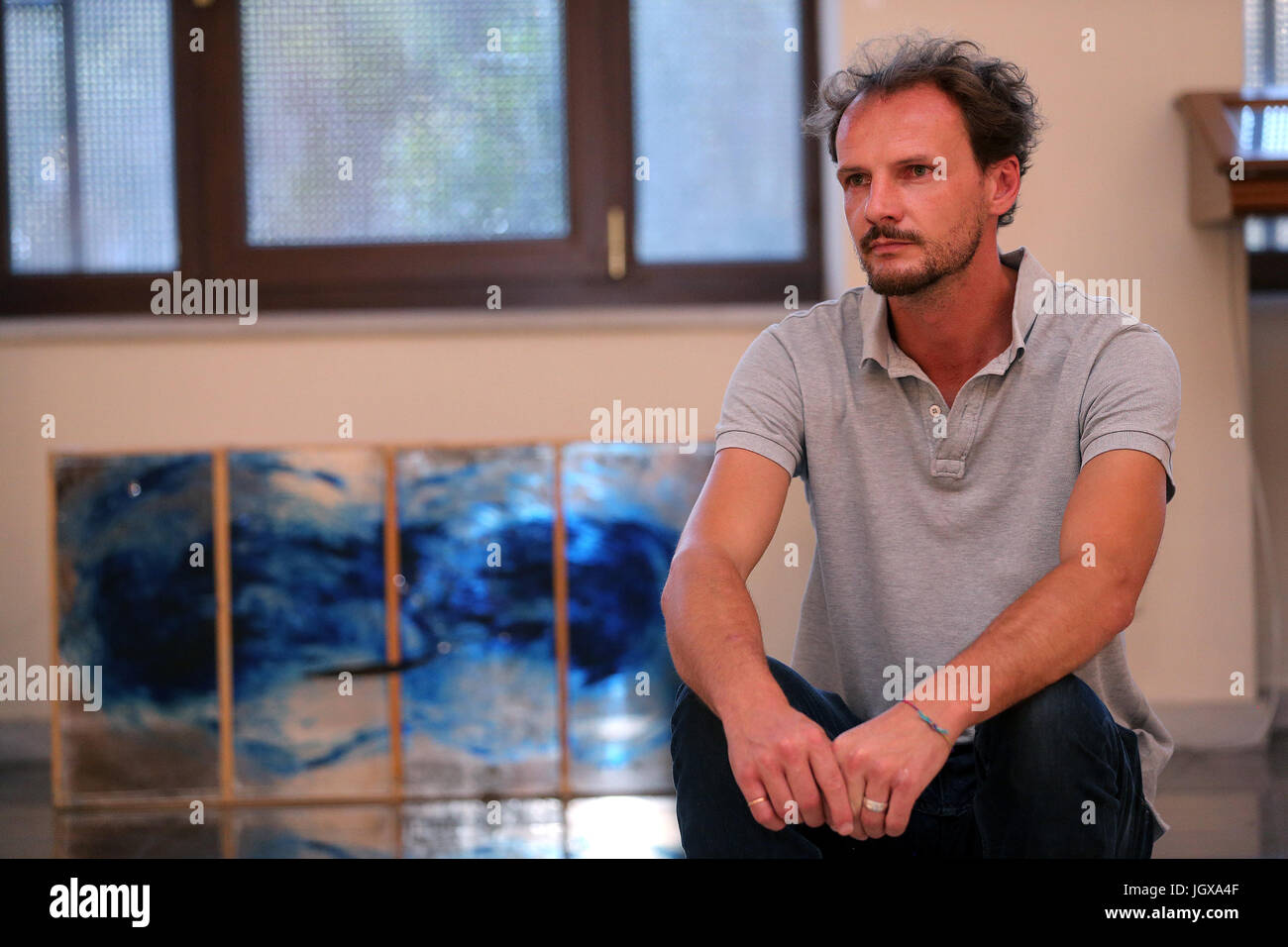 (170711) -- ATHENS, July 11, 2017 (Xinhua) -- Photo taken on July 5 shows Italian artist Paolo Ghezzi among the works he has created with Nadia Antonello at the exhibition 'All the Stars, All the Seas' in Athens, Greece. Two years into the crisis which has tested Europe, Italian art collective Antonello Ghezzi chose Greece, a country at the forefront of the mass influx of refugees and migrants, to launch their new project aimed to convey the message of unity and solidarity. 'The exhibition 'All the Stars, All the Seas' is dedicated to the migrants and refugees, to all people adrift and to the Stock Photo