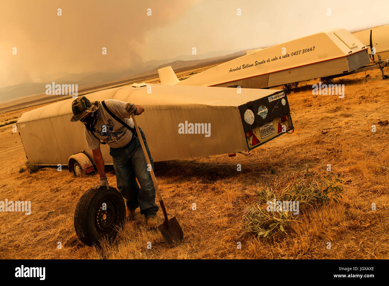 Avenal, California, USA. 11th July, 2017. Resident CARLOS GRAJEDA, 62, cleans up an airfield for glider aircraft as the Garza fire burns west of Avenal, California. Credit: Joel Angel Juarez/ZUMA Wire/Alamy Live News Stock Photo