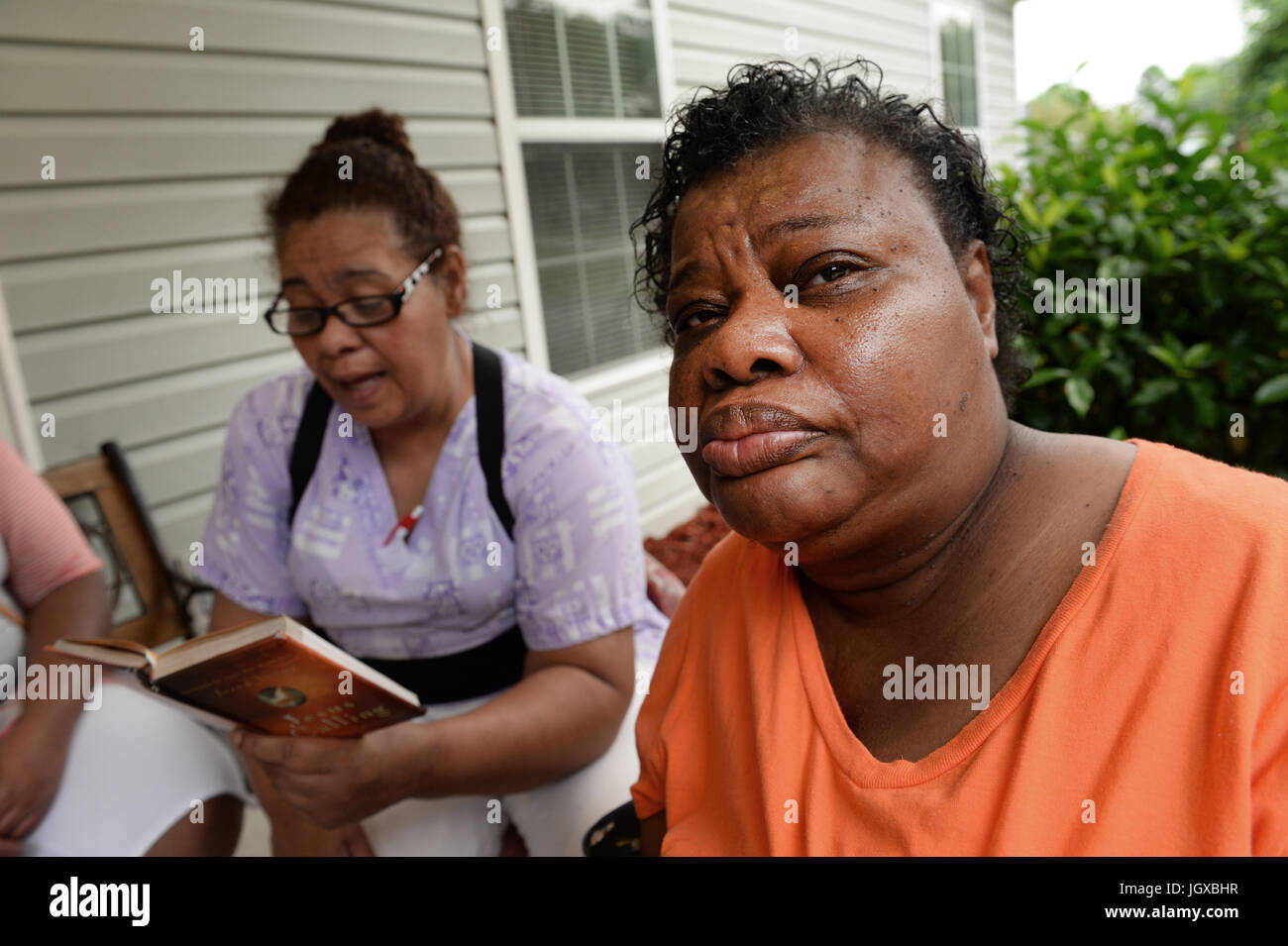 Waycross, GA, USA. 16th Sep, 2014. Caregiver reads Bible stories to