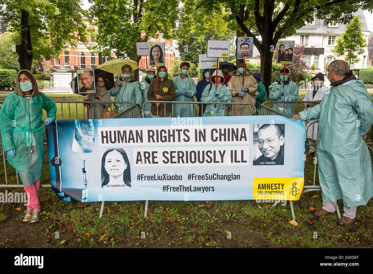 Brussels, Belgium. 12th July, 2017. Human rights activists hold the protest in front of Chinese Embassy in Brussels, Belgium on 12.07.2017 Protestors dress us as doctors, to symbolize the care to be given to human rights and defenders in China. Activists focus on the case of Chinese Nobel Peace Prize winner Liu Xiaobo, a prisoner of conscience, who is in palliative care for liver cancer. Liu Xiaobo has no opportunity to travel abroad to be followed by specialists of his choice. Credit: ZUMA Press, Inc./Alamy Live News Stock Photo