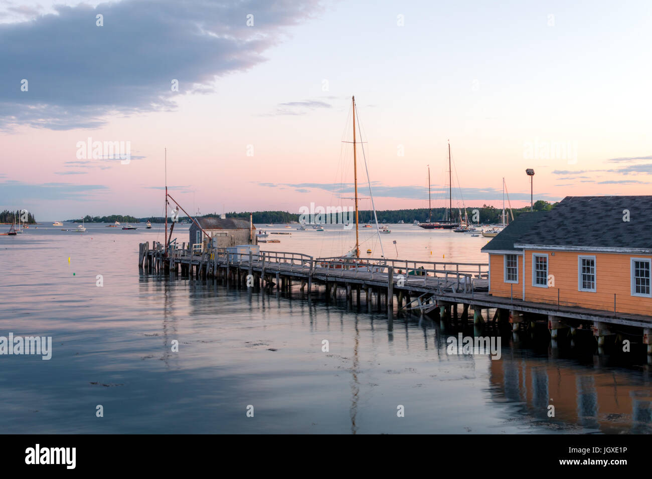 Boathouse and dock in the calm and beautiful Boothbay Harbor at dusk Stock Photo