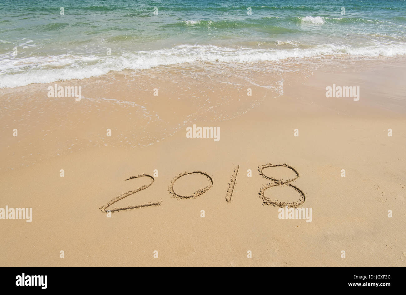 2018 written in sand write on tropical beach Stock Photo