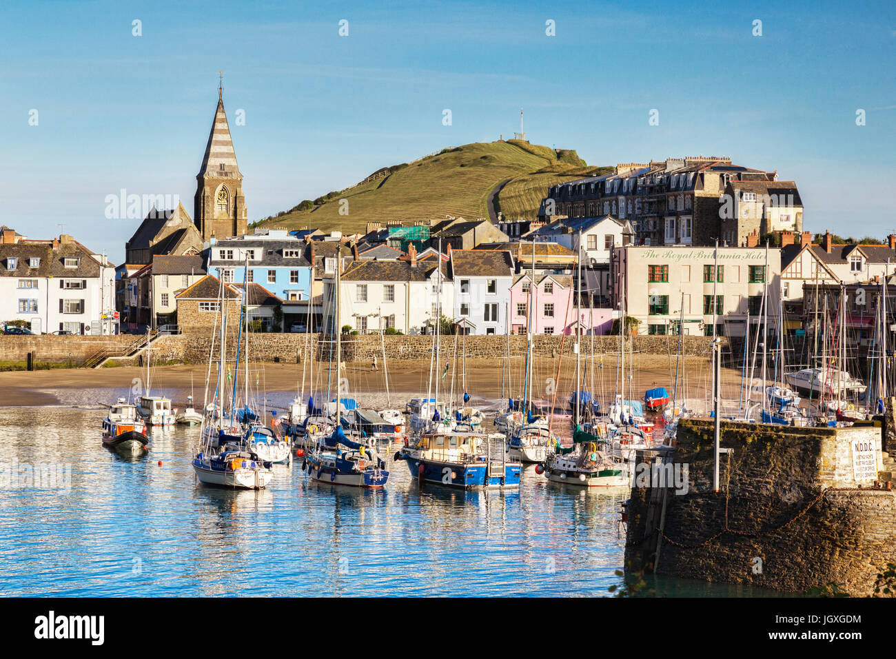 14 June 2017: Ilfracombe, North Devon, England, UK - The harbour on a bright sunny morning in summer, with Capstone Hill in the background. Stock Photo